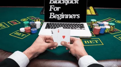 Laptop on blackjack table showing the words Blackjack for beginners