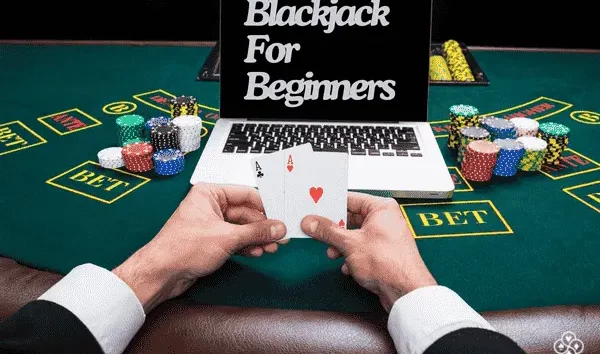 Laptop on blackjack table showing the words Blackjack for beginners